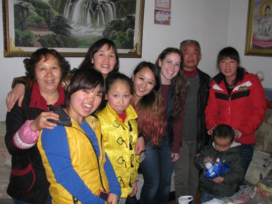 Kathy (in blue and yellow), her family, Urey, and me after dinner.